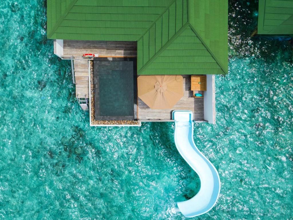 - These playful Water Villas offer a private pool with an exhilarating slide, making your stay unforgettable. Enjoy your own sundeck with loungers, a bathroom with an indoor shower, mini bar, and Wi-Fi. With stunning views and the lagoon just steps away, it's the perfect blend of fun and relaxation.
