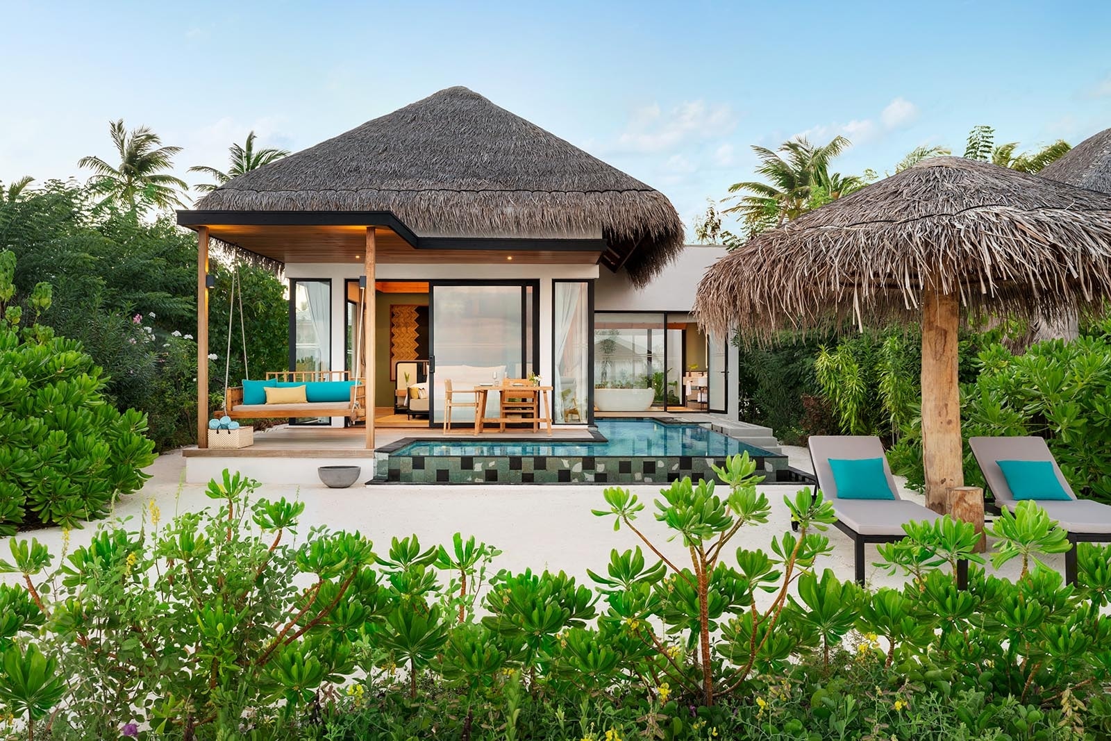 - 138 sq. m. / 1485 sq. ft., sofa bed, private pool, direct beach access
- This well-designed villa with direct beach access accommodates up to 2 adults and 2 children below 12 years. The lushly landscaped outdoor space features space to play: a pool and sundeck with dining area and a swing, and a gazebo with sun loungers.
- The villa includes a king-size bed, comfortably sized sofa bed, complimentary WiFi, coffee / tea facilities, a 55-inch HDTV, laptop safe, air conditioning, mini bar, and ceiling fan. Additional amenities include an ensuite bathroom, outdoor shower, bathrobes, and slippers. Sleeps 3 adults with a sofa bed.