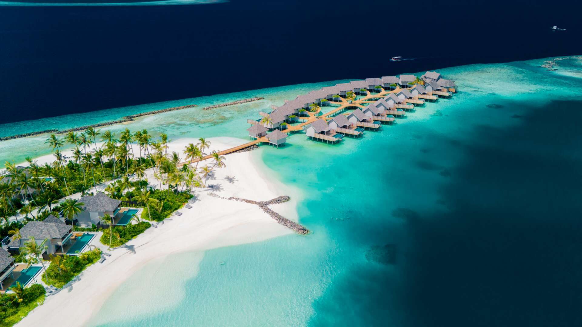 ananea Madivaru Maldives is a contemporary luxury resort located in the heart of North Ari Atoll, offering a blend of modern elegance, authentic Maldivian charm, and exceptional marine experiences. Built across two tropical islands connected by an overwater walkway, the resort is surrounded by a crystal-clear lagoon, white sandy beaches, and a vibrant house reef rich with marine life.
The resort features over 110 private pool villas and residences designed with minimalist luxury, natural materials, and contemporary island aesthetics. It is ideal for honeymooners, couples, families, and snorkeling enthusiasts looking for both privacy and diverse resort facilities