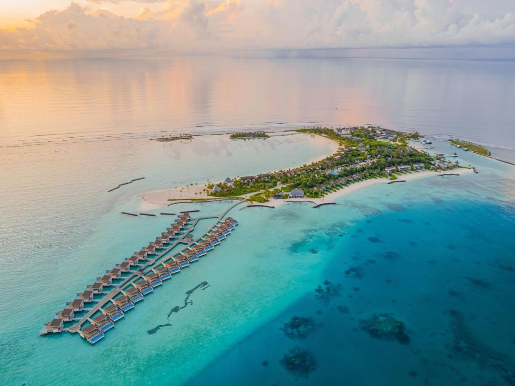 Kuda Villingili Resort Maldives is a luxurious island retreat located in the beautiful North Malé Atoll, offering an exceptional blend of elegance, privacy, and relaxation. Surrounded by crystal-clear turquoise waters and pristine white sandy beaches, the resort features spacious beach villas and stunning overwater villas designed with contemporary style and breathtaking ocean views.
The resort is renowned for its warm hospitality and world-class facilities, including a variety of fine dining restaurants, stylish bars, and one of the largest swimming pools in the Maldives. Guests can enjoy unforgettable experiences such as surfing, diving, snorkeling, water sports, spa treatments, and sunset cruises, making it an ideal destination for couples, honeymooners, families, and luxury travelers.
With its tranquil atmosphere, sophisticated design, and outstanding service, Kuda Villingili Resort Maldives delivers a truly memorable tropical escape in the heart of the Maldives.