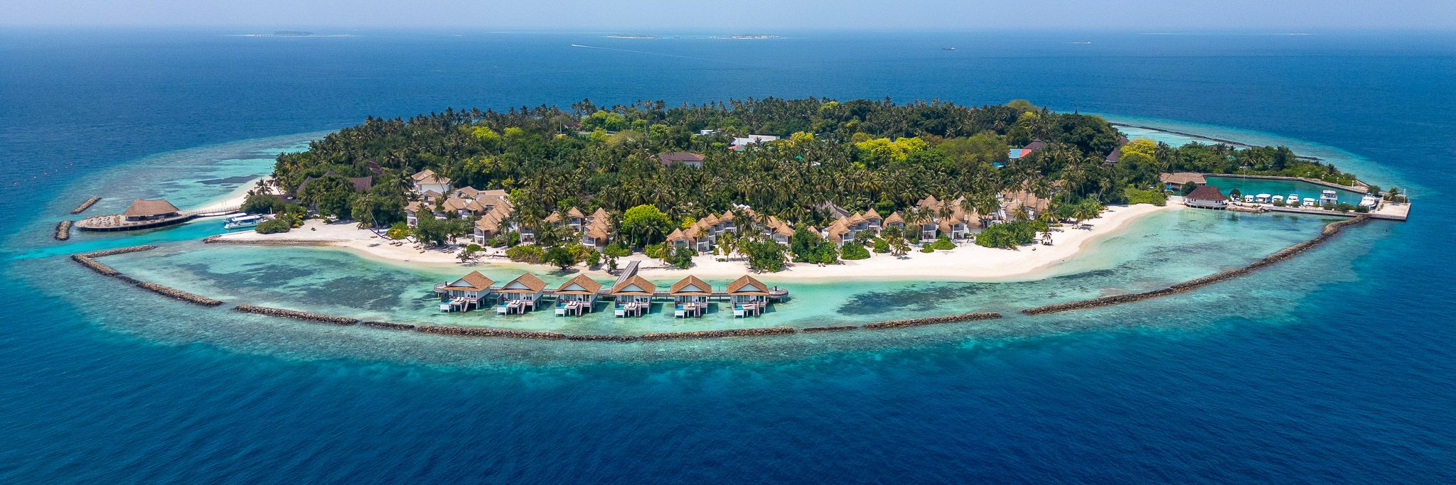 Bandos Maldives is a renowned tropical island resort located in the heart of the North Malé Atoll, offering a perfect blend of natural beauty, comfort, and authentic Maldivian hospitality. Surrounded by crystal-clear lagoons, lush tropical greenery, and pristine white sandy beaches, the resort provides an unforgettable island getaway just a short speedboat ride from Malé International Airport.
The resort features a variety of stylish accommodations, including beachfront rooms, garden villas, and luxurious overwater villas designed to provide comfort, privacy, and breathtaking ocean views. Guests can enjoy a wide range of dining options, international cuisines, and vibrant island experiences tailored for couples, families, and honeymooners alike.
Bandos Maldives is also famous for its exceptional diving and snorkeling opportunities, water sports activities, wellness spa, and family-friendly atmosphere. Combining relaxation, adventure, and world-class service, the resort offers a truly memorable Maldivian escape for travelers seeking both luxury and tranquility.