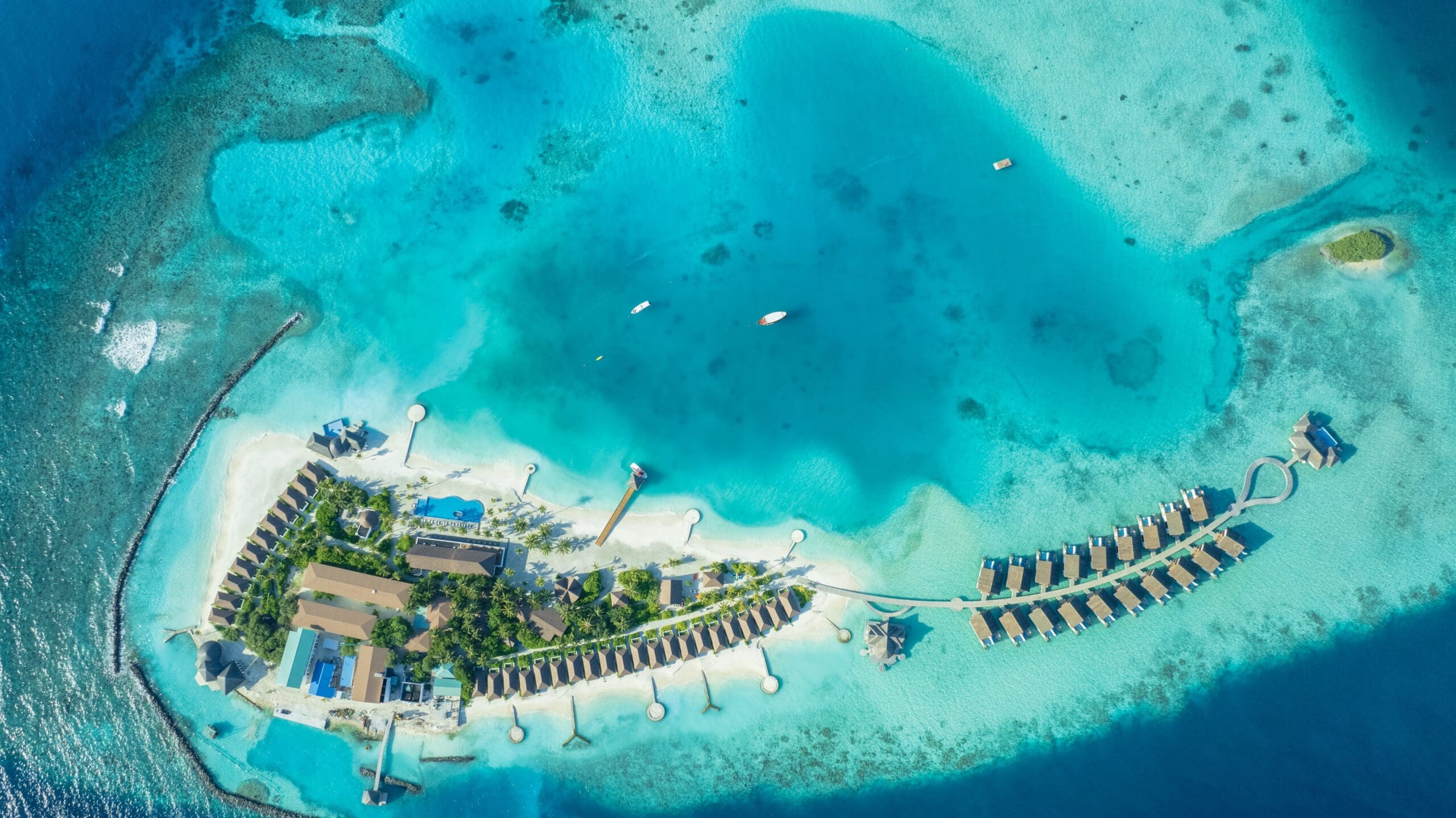 Located in the breathtaking Vaavu Atoll, NOOE Maldives Kunaavashi is a contemporary luxury island resort designed to offer guests the perfect balance of relaxation, adventure, and authentic Maldivian beauty. Surrounded by crystal-clear turquoise lagoons, white sandy beaches, and vibrant marine life, the resort provides an unforgettable tropical escape ideal for honeymooners, couples, and families. Known as the “Wow Atoll,” Vaavu Atoll is famous for its incredible diving and snorkeling experiences, including encounters with nurse sharks and colorful coral reefs.
The resort features stylish Beach Villas, Sunset Beach Villas, and spacious Duplex Overwater Villas with private pools, all thoughtfully designed with modern elegance and stunning ocean views. Guests can indulge in diverse culinary experiences across several dining venues inspired by Mediterranean, Japanese, Maldivian, and international flavors. NOOE Maldives Kunaavashi also offers a wide range of experiences including sunrise yoga, spa treatments, water sports, diving excursions, dolphin cruises, and romantic private dining under the stars. Conveniently accessible by a scenic seaplane or speedboat transfer from Malé, the resort promises a luxurious island getaway where tranquility and adventure exist in perfect harmony.