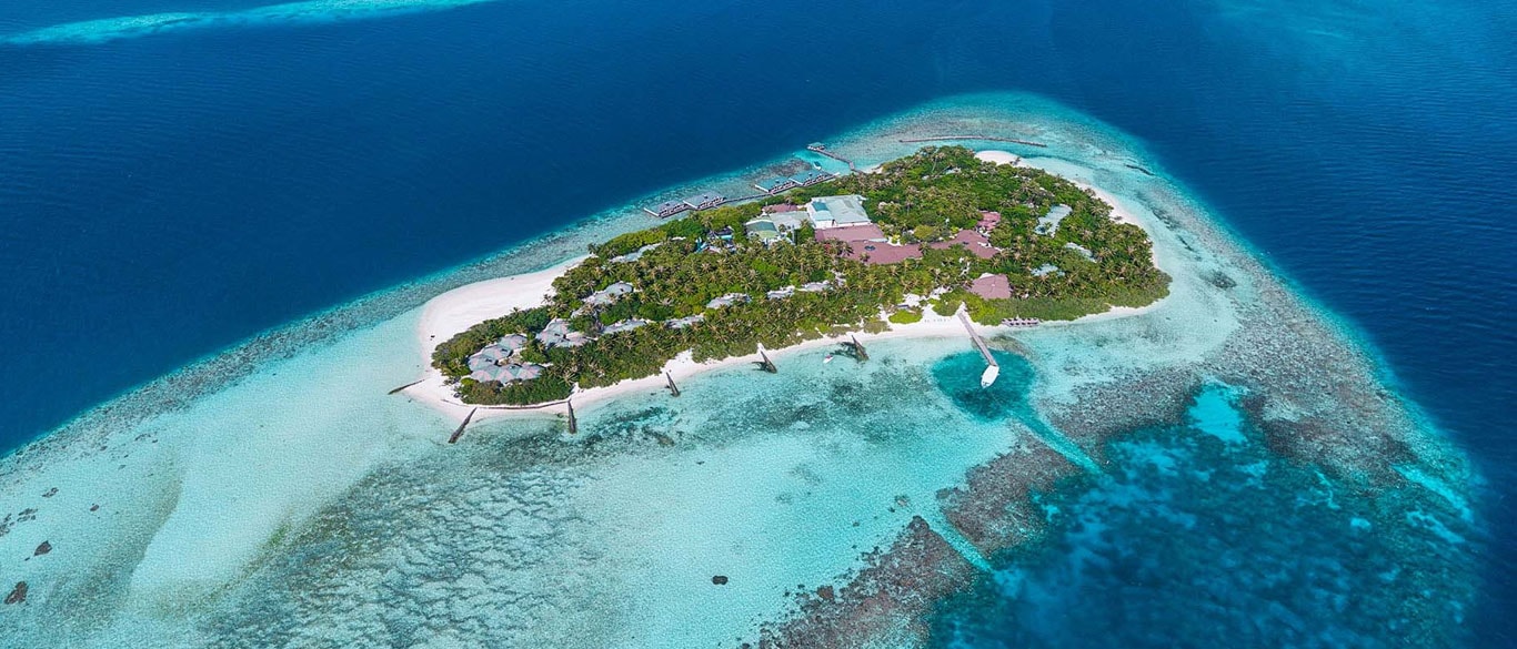 Embudu Village Maldives is a charming island resort located in the beautiful South Malé Atoll, offering a peaceful and authentic Maldivian escape surrounded by crystal-clear waters, white sandy beaches, and vibrant tropical scenery. Known for its relaxed atmosphere and natural beauty, the resort is an ideal destination for travelers seeking tranquility, adventure, and unforgettable underwater experiences.
The resort features comfortable beachfront and overwater accommodations designed in a simple yet cozy island style, allowing guests to enjoy direct access to the beach and breathtaking views of the Indian Ocean. The lush greenery and serene environment create the perfect setting for relaxation and a true tropical getaway.
Embudu Village Maldives is especially popular for its exceptional snorkeling and diving opportunities, thanks to its stunning house reef filled with colorful marine life. Guests can also enjoy water sports activities, relaxing spa treatments, and international dining experiences while experiencing warm Maldivian hospitality. Combining comfort, nature, and adventure, the resort offers a memorable island vacation in the heart of the Maldives