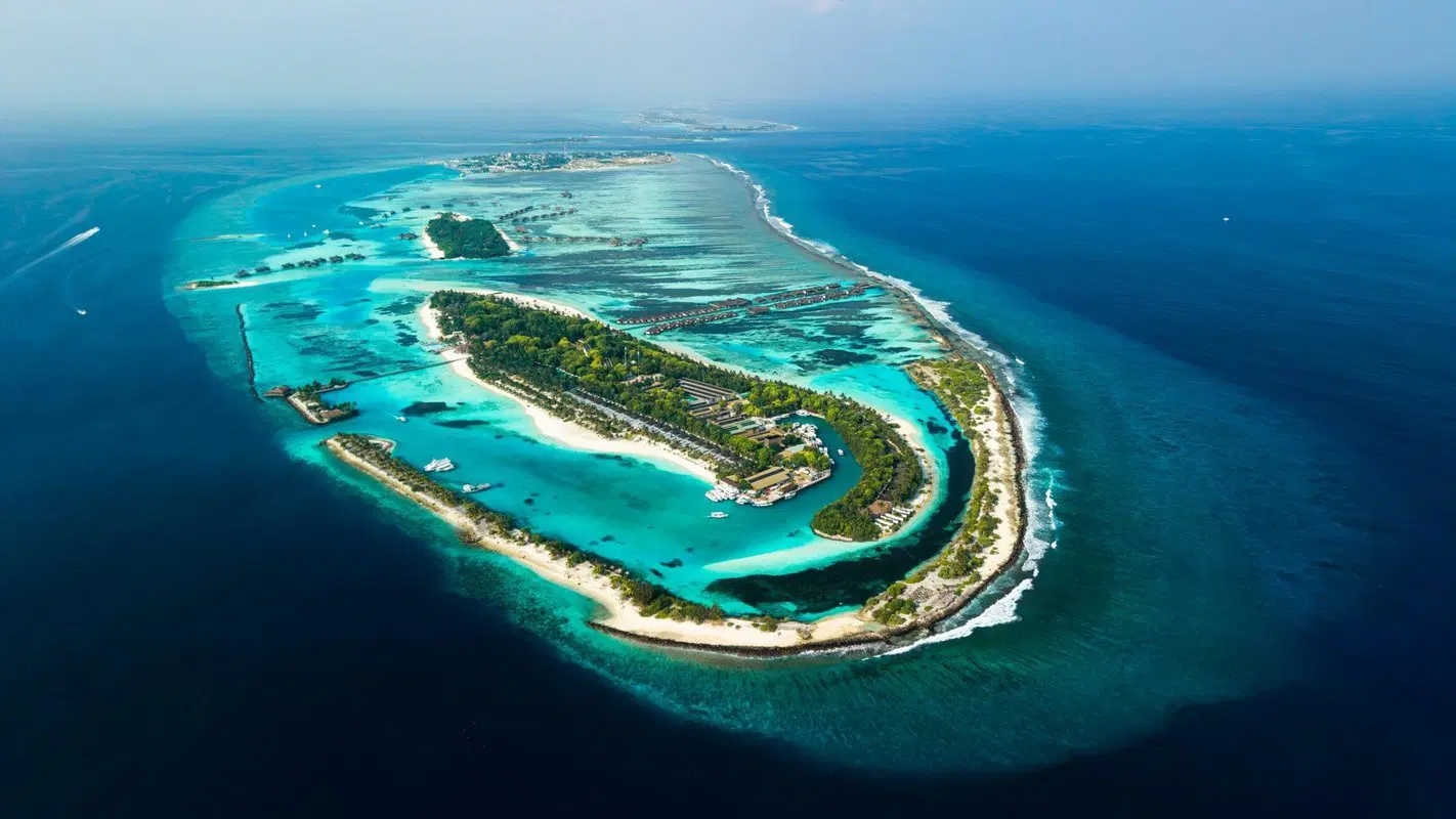 Located in the stunning North Malé Atoll, Villa Nautica is a vibrant luxury island resort that perfectly blends tropical beauty with a chic nautical lifestyle. Formerly known as Paradise Island Resort, the resort has been beautifully rebranded with stylish contemporary interiors, upgraded villas, and lively social spaces inspired by glamorous yacht life. Surrounded by crystal-clear lagoons, white sandy beaches, and lush tropical greenery, Villa Nautica offers a lively yet relaxing atmosphere ideal for couples, honeymooners, families, and groups of friends. One of its biggest advantages is its convenient location, just 20 minutes by speedboat from Velana International Airport, making it one of the easiest luxury resorts to access in the Maldives.
The resort features a wide selection of beachfront and overwater villas, including private pool villas and luxurious ocean suites designed with elegant modern touches and breathtaking ocean views. Guests can enjoy multiple restaurants and bars offering international, seafood, Italian, and Japanese cuisine, along with relaxing treatments at the Araamu Spa, exciting diving and snorkeling experiences, water sports, sunset cruises, and family-friendly activities at the kids club. Known for its vibrant atmosphere, excellent facilities, and great value for money, Villa Nautica delivers an unforgettable Maldivian escape filled with comfort, adventure, and island sophistication.
