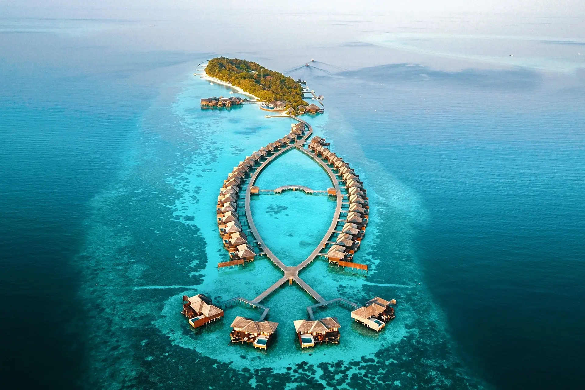 Nestled in the beautiful South Ari Atoll, Lily Beach Resort & Spa is one of the Maldives’ leading luxury all-inclusive resorts, offering an exceptional blend of elegance, comfort,
and tropical beauty. Surrounded by crystal-clear turquoise waters, white sandy beaches, and vibrant coral reefs, the resort provides an unforgettable island experience for couples, honeymooners, and families alike. Renowned for its award-winning Platinum Plan, Lily Beach delivers a premium all-inclusive concept with world-class dining, premium beverages, and outstanding personalized service.
The resort features a stunning collection of beach villas and overwater villas, many with private pools and direct lagoon access, designed with a perfect balance of modern luxury and Maldivian charm. Guests can enjoy a wide range of experiences including fine dining restaurants, relaxing treatments at Tamara Spa, snorkeling and diving adventures, dolphin cruises, and exciting water sports activities. With its breathtaking surroundings and exceptional hospitality, Lily Beach Resort & Spa promises a truly luxurious escape in the heart of the Maldives.