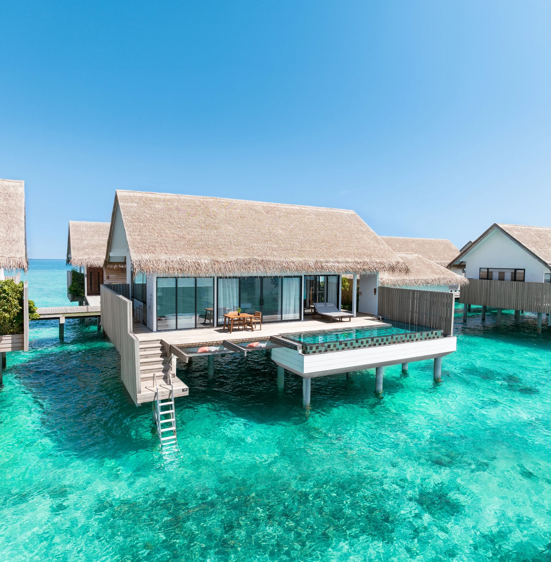 - 154 sq. m. / 1657 sq. ft., private pool, direct access to ocean
- This beautiful villa provides a sense of island living, with direct access to the ocean. A glass panel in the floor allows views of the turquoise waters below. The outdoor space features a pool and sundeck with dining area, sun loungers, and a hammock.
- The villa includes a king-size bed, complimentary WiFi, coffee / tea facilities, a 55-inch HDTV, laptop safe, air conditioning, mini bar, and ceiling fan. Additional amenities include an ensuite bathroom, outdoor shower, bathrobes, and slippers. Sleeps 3 with a rollaway bed.