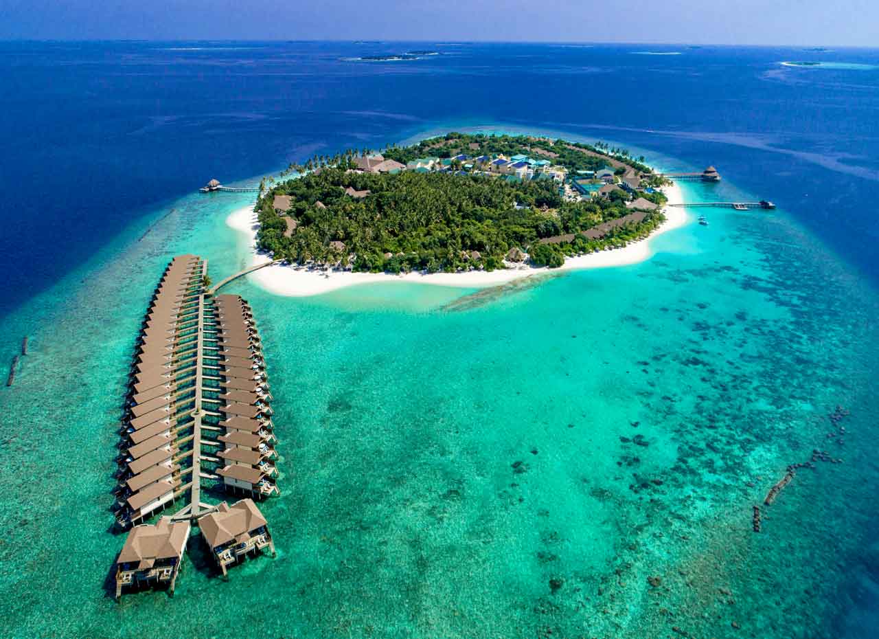 Reethi Faru Resort is a luxurious eco-friendly island resort located on the private island of Filaidhoo in the stunning Raa Atoll. Surrounded by crystal-clear turquoise waters, white sandy beaches, and a vibrant house reef, the resort offers the perfect blend of natural beauty, relaxation, and authentic Maldivian hospitality.
The resort features elegant beach and overwater villas designed with tropical style and modern comfort, making it ideal for honeymooners, couples, families, and diving enthusiasts. Guests can enjoy direct beach access, breathtaking ocean views, and peaceful privacy throughout the island