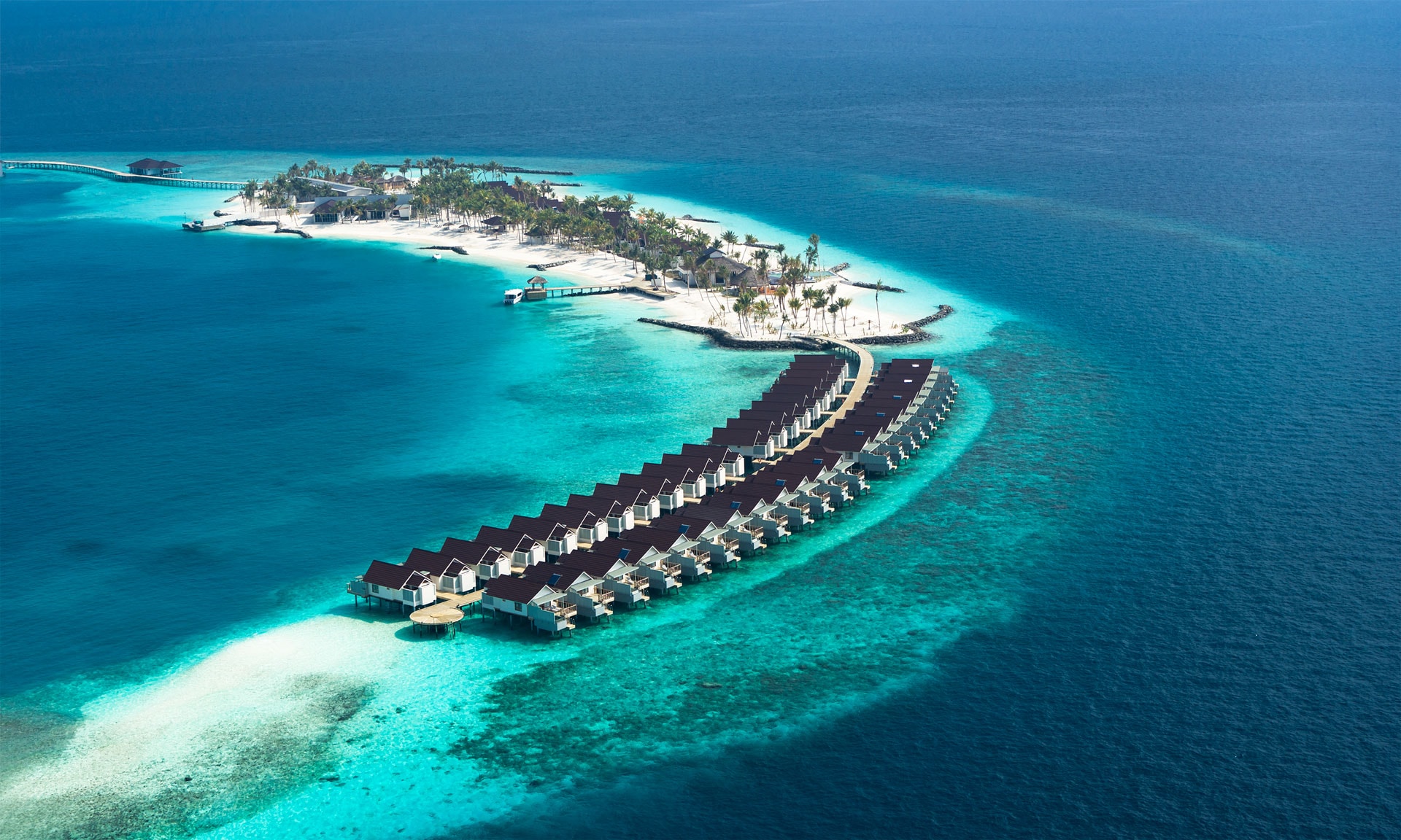 OBLU SELECT Lobigili is a luxurious adults-only resort located in the North Malé Atoll, just 15 minutes by speedboat from Velana International Airport. The name “Lobigili” translates to “Island of Love” in the local Dhivehi language, making it an ideal destination for honeymooners and couples seeking a romantic escape.
The resort features stylish beach and overwater villas, many with private pools and breathtaking views of the turquoise lagoon. Designed exclusively for adults, OBLU SELECT Lobigili offers a peaceful and intimate atmosphere combined with contemporary Maldivian luxury.
One of the resort’s highlights is the famous Only BLU Underwater Restaurant, one of the largest underwater dining experiences in the Maldives, offering an unforgettable culinary journey beneath the ocean.