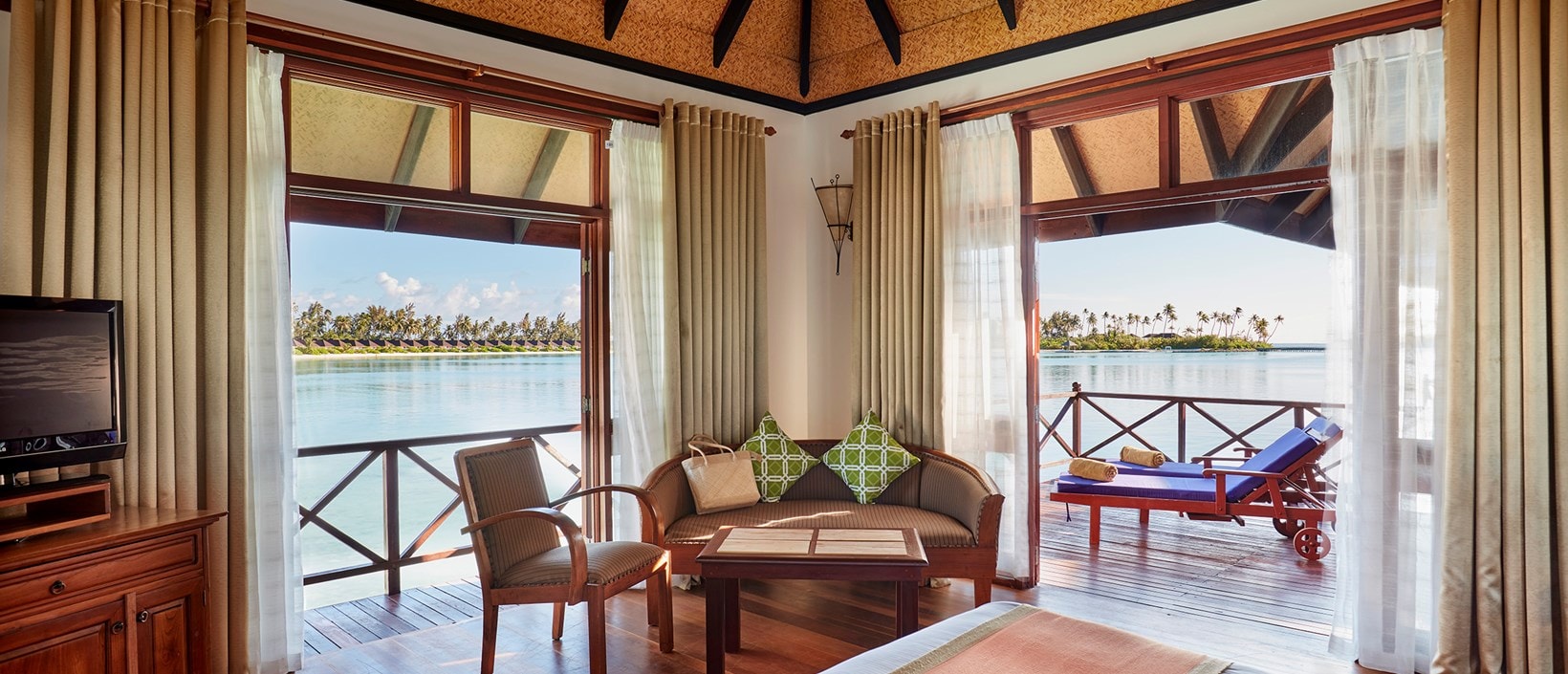 - With its shingled roof and dark wood furnishings, this villa exudes a traditional charm. The wooden sundeck is the perfect spot to soak up the sun and take in the views of the various islands that make up the Olhuveli compound. Our standard overwater level is the perfect hideaway for two.